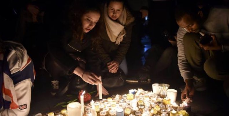 People light candles at a vigil in Trafalgar Square the day after an attack, in London