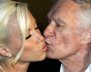 FILE PHOTO -  Playboy magazine founder Hugh Hefner kisses girlfriend Kendra Wilkinson after their arrival for his 80th birthday party in Munich