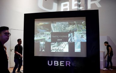 A screen shows the traffic conditions in cities across Asia during an Uber event in Singapore
